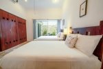 Guest suite with 2 double beds, en suite bathroom, TV and private patio access